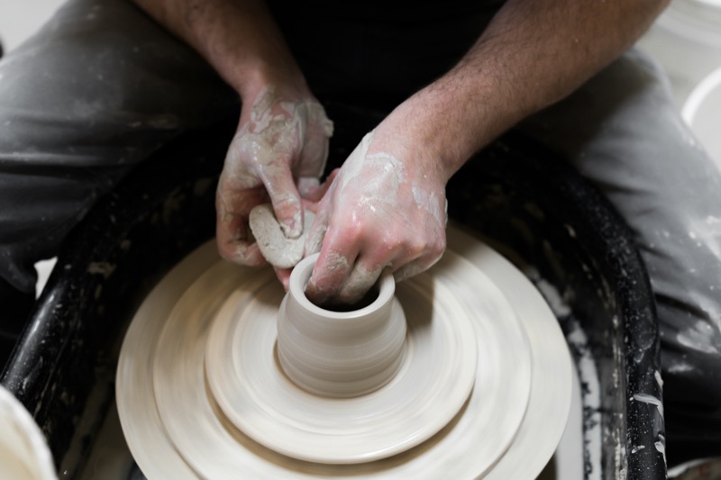 Potter working clay from above on the wheel