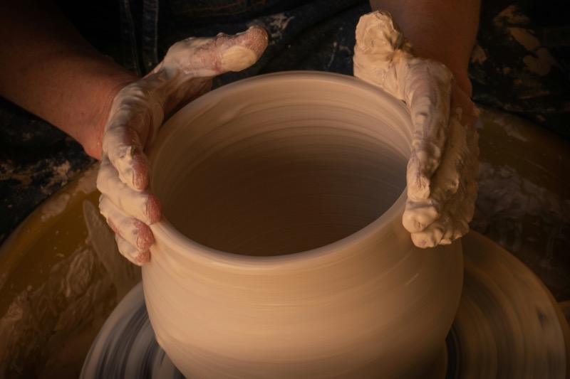 Shaping a large clay vessel by hand