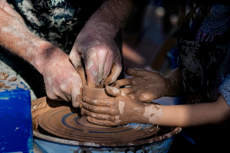 Family pottery workshop with adult and child